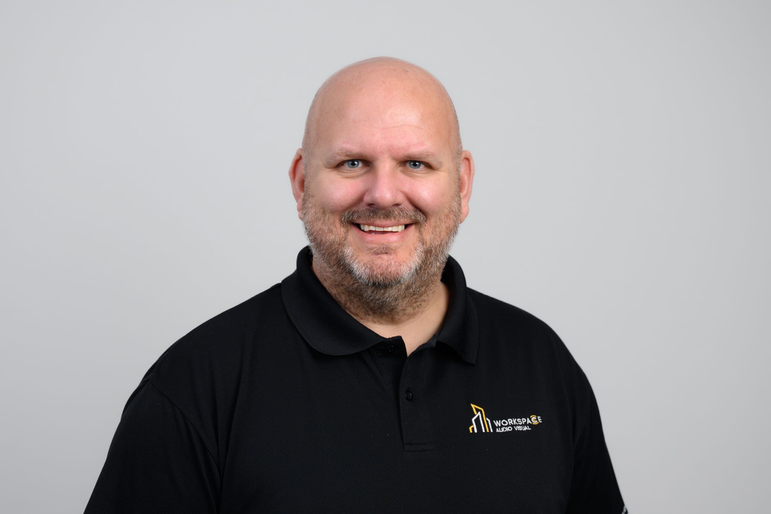 man with a bald head and a black shirt